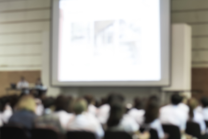 Blurred abstract background of business or educational conference seminar in auditorium hall