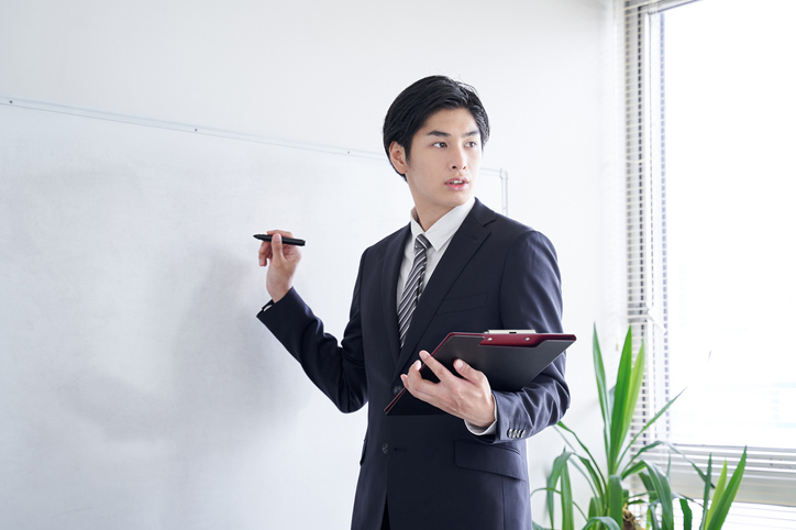 A Japanese male businessman practicing his presentation