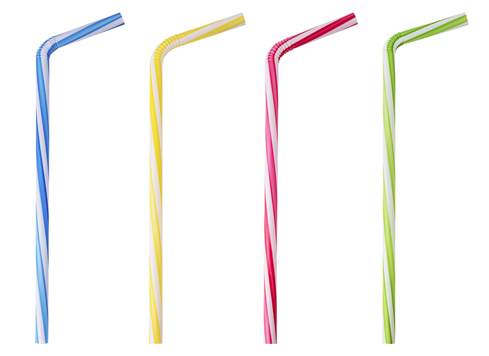 Four drinking straw pink, blue, yellow, green striped isolated on white background. Clipping Path. Full depth of field.
